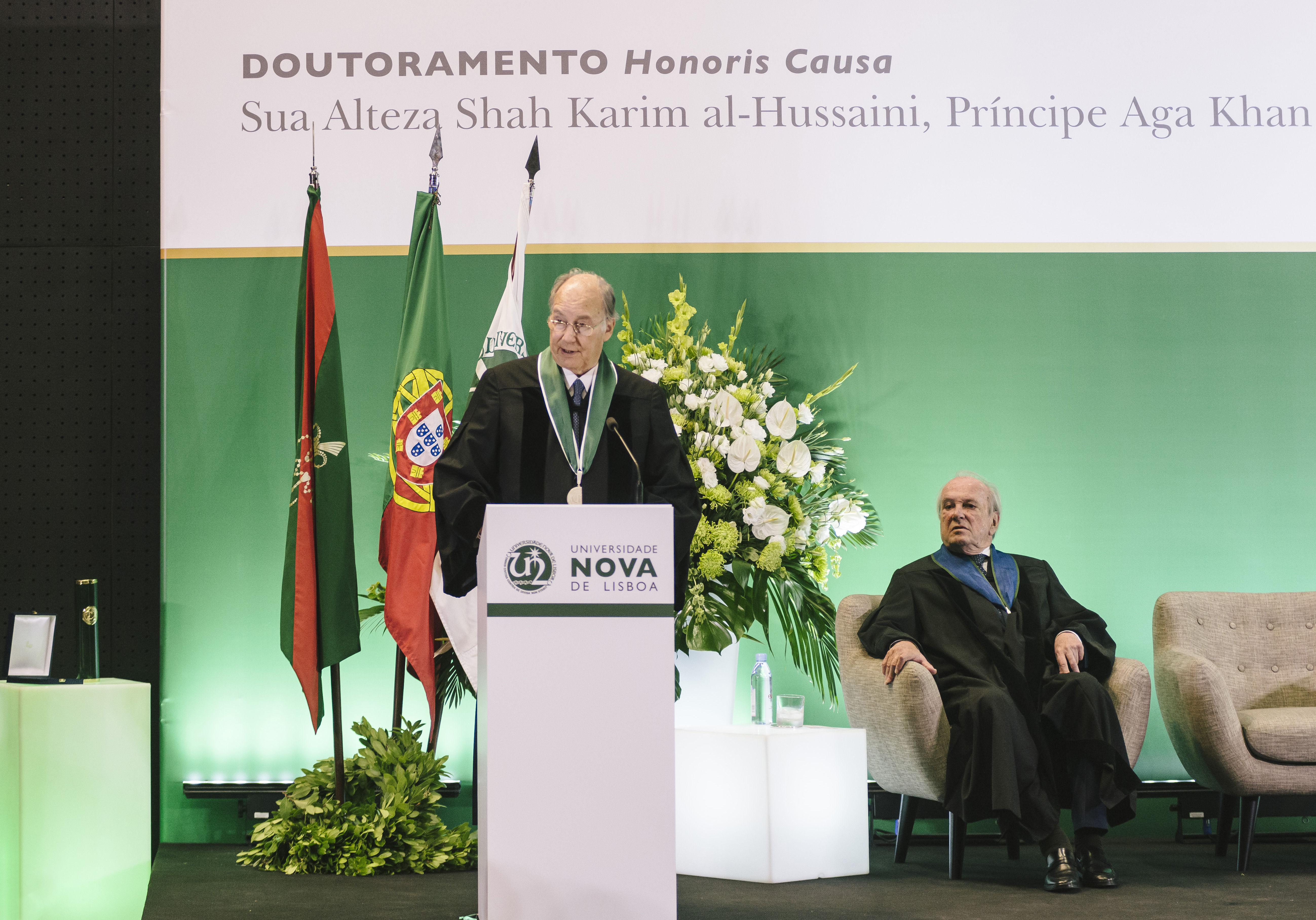 His Highness the Aga Khan delivers his acceptance remarks upon receiving an Honorary Doctorate from Universidade NOVA de Lisboa as Dr. Francisco Pinto Balsemão, Patron of the Doctorate looks on. | AKDN/Antonio Pedrosa