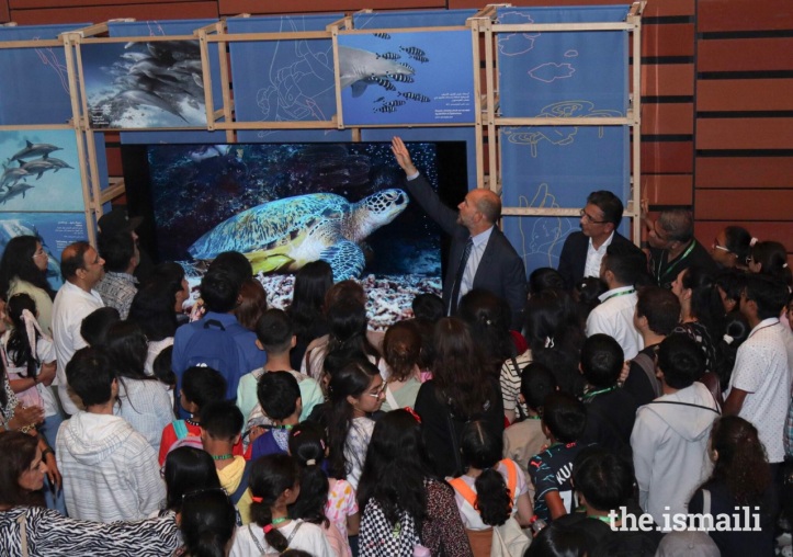 Prince Hussain Aga Khan tells students the story behind an image in his Fragile Beauty exhibition.